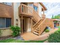 Condo entrance with wooden staircase and landscaping at 4027 Davit Dr, New Port Richey, FL 34652