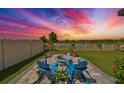 Landscaped backyard with fire pit and seating area at sunset at 5429 Rainwood Meadows Dr, Apollo Beach, FL 33572