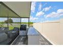 Outdoor kitchen with granite countertop and built-in grill at 5429 Rainwood Meadows Dr, Apollo Beach, FL 33572