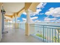 Spacious balcony overlooking waterfront, featuring teal railings and columns at 700 N Osceola Ave # 702, Clearwater, FL 33755