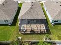 Single-story home with a screened patio and grassy backyard at 1523 Glen Grove Loop, Wesley Chapel, FL 33543