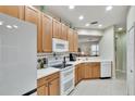 Bright kitchen with white appliances and light wood cabinets at 242 Shell Falls Dr, Apollo Beach, FL 33572