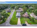 Aerial view of a house with a driveway and a green lawn at 1311 E Church St, Plant City, FL 33563