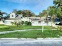 Single story house with attached garage, landscaping, and a for sale sign at 2229 Arch Mcdonald Dr, Dover, FL 33527