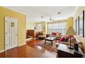 Spacious living room with hardwood floors, soft, inviting furniture and large bright windows at 2947 Bayshore Pointe Dr, Tampa, FL 33611