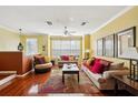 Bright living room with hardwood floors, large windows, and comfortable seating, perfect for relaxation at 2947 Bayshore Pointe Dr, Tampa, FL 33611