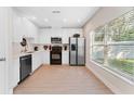 Modern kitchen with stainless steel appliances and white cabinets at 2944 Prairie Iris Dr, Land O Lakes, FL 34638