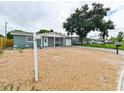 Newly painted teal single-story home with a gravel yard and a two car garage at 3542 Connon Dr, New Port Richey, FL 34652