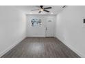 Cozy living room features modern gray flooring, natural light, and white walls at 541 E Lime St, Tarpon Springs, FL 34689