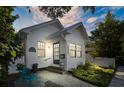 Charming white bungalow with landscaped yard and walkway at 1617 Oak Ne St, St Petersburg, FL 33704