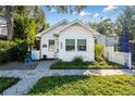 White bungalow house with hexagonal pavers and well-manicured lawn at 1617 Oak Ne St, St Petersburg, FL 33704
