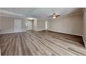 Spacious living room featuring wood-look floors and neutral paint, bathed in natural light at 6969 Oldgate Cir, New Port Richey, FL 34655