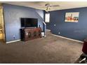 Spacious living room with carpet flooring and a large TV at 32425 Fish Hook Loop, Wesley Chapel, FL 33545
