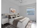 Spacious bedroom with plush bedding, nightstands and large window at 819 Tremont Greens Ln, Sun City Center, FL 33573