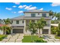 Two-story house with a modern design, metal roof, and a large driveway at 7949 2Nd S Ave, St Petersburg, FL 33707