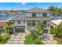 Modern home with water access, showcasing a metal roof and expansive driveway at 7949 2Nd S Ave, St Petersburg, FL 33707