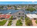 Two-story house with modern design, metal roof, and canal views at 7949 2Nd S Ave, St Petersburg, FL 33707