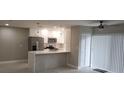 Modern kitchen with white cabinets, quartz countertops and gold fixtures at 5980 80Th N St # 106, St Petersburg, FL 33709