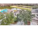 Aerial view of house and surrounding landscape, including a pond at 10918 Ancient Futures Dr, Tampa, FL 33647