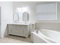 Elegant bathroom with double vanity and garden tub at 10918 Ancient Futures Dr, Tampa, FL 33647