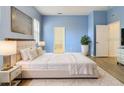 Spacious main bedroom with plush bedding and ample natural light at 10918 Ancient Futures Dr, Tampa, FL 33647