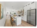 Modern kitchen with white cabinetry, stainless steel appliances, and an island at 1518 E Knollwood St, Tampa, FL 33610