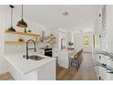 Modern kitchen with white cabinetry, stainless steel appliances, and an island at 1518 E Knollwood St, Tampa, FL 33610