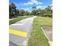 Paved walking path with green space on either side at 3600 Magnolia Ridge Cir # 1221-G, Palm Harbor, FL 34684