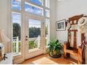 Bright foyer with a soaring window, hardwood floors, and charming decorative accents at 6231 Bayshore Blvd, Tampa, FL 33611