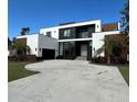 Modern two-story home with a large driveway and landscaped lawn at 1076 Snell Isle Ne Blvd, St Petersburg, FL 33704