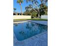 Inviting rectangular pool with large gray tile deck at 4310 Huntington Ne St, St Petersburg, FL 33703