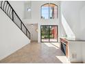 Bright living room with high ceilings, tile floors, and sliding glass doors leading to a patio at 2725 Via Cipriani # 715B, Clearwater, FL 33764