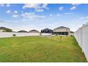 Huge backyard featuring a well-maintained lawn and a white fence, offering privacy and plenty of room for recreation at 3314 San Moise Pl, Plant City, FL 33567