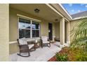 Inviting front porch features neutral rocking chairs, fresh landscaping, and natural light at 3314 San Moise Pl, Plant City, FL 33567