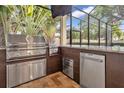 Outdoor kitchen with stainless steel appliances and granite countertops at 4114 W Zelar St, Tampa, FL 33629