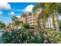 Luxury condo building with tropical landscaping at 7296 Marathon Dr # 603, Seminole, FL 33777