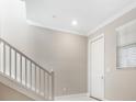 Modern staircase with white railings leading to the second floor at 9612 Little Bluestem Dr, Land O Lakes, FL 34637