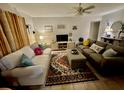 Cozy living room featuring comfortable sofas, a large TV, and decorative accents at 2625 State Road 590 # 2412, Clearwater, FL 33759