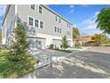 Rear view of townhouses showcasing attached garages and landscaping at 208 W Frances Ave # 2, Tampa, FL 33602