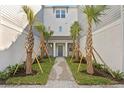 Shared courtyard with brick pavers and tropical landscaping between townhouses at 208 W Frances Ave # 5, Tampa, FL 33602