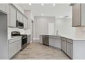 Modern kitchen with gray cabinets, stainless steel appliances, and white quartz countertops at 2424 Wise River Ln, Zephyrhills, FL 33544