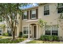 Attractive tan townhome with a tree and walkway at 4517 Kennewick Pl, Riverview, FL 33578