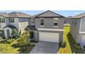 Two-story house, gray siding, two-car garage, and small yard at 9917 Spanish Lime Ct, Riverview, FL 33578