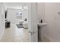 Small bathroom with pedestal sink and mirror at 9917 Spanish Lime Ct, Riverview, FL 33578