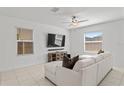 Living room featuring a sectional sofa and large TV at 9917 Spanish Lime Ct, Riverview, FL 33578