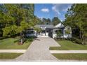 Exterior of a single story home with a stone driveway and landscaping at 4586 Hickory Oak Dr, Brooksville, FL 34601