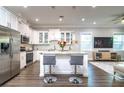 Modern kitchen with white cabinets, stainless steel appliances, and a kitchen island with bar stool seating at 3604 W Paxton Ave, Tampa, FL 33611