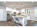 Bright kitchen featuring white cabinetry, granite countertops, stainless steel appliances, and a kitchen island at 3604 W Paxton Ave, Tampa, FL 33611