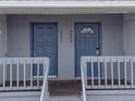 Two building entrances with blue doors and gray railings at 4883 W Mcelroy Ave # G211, Tampa, FL 33611