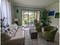 Bright living room with patio access and comfortable seating at 8219 Caponata Blvd, Seminole, FL 33777